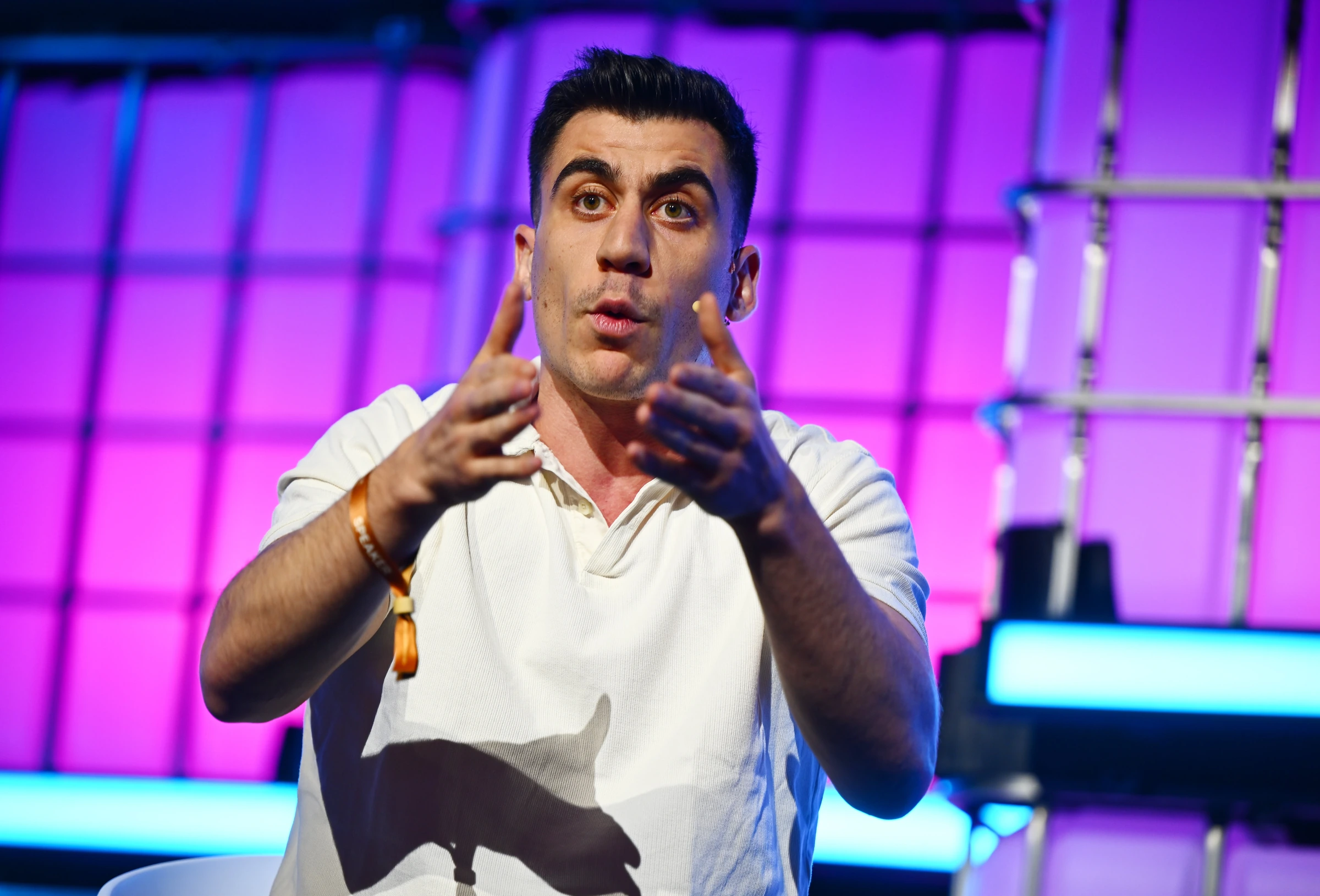 Fidias speaking and gesturing on stage at Web Summit 2025
